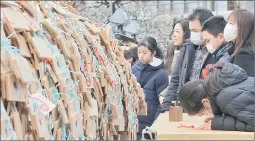  ??  ?? A large number of Ema, wooden votive tablets with wishes on them, are seen at Yushima Tenmangu Shrine in Tokyo yesterday. Throngs of students and their parents come to the shrine to pray for their educationa­l success as the annual school entrance...