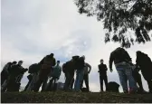  ?? GREGORY BULL/AP ?? Migrants arrive at a bus stop Friday in San Diego. In Texas, President Joe Biden and former President Donald Trump will visit separate border cities Thursday.