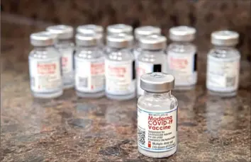  ?? Alexandra Wimley/Post-Gazette ?? Empty vials of the Moderna COVID-19 vaccine are placed on a counter last month at St. Marys Pharmacy in St. Marys, Elk County. Moderna’s vaccine is mostly going to wealthy countries, leaving poorer countries locked out.