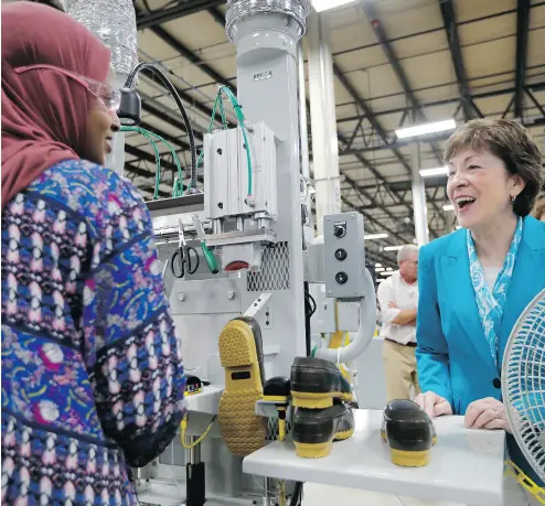  ?? ROBERT F. BUKATY / THE ASSOCIATED PRESS ?? U. S. Senator Susan Collins speaks with a worker at L.L. Bean’s new manufactur­ing centre in Lewiston, Maine. The Maine-based retailer is focusing on its roots as a supplier of outdoors goods, while pruning its product lineup.