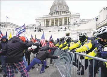  ?? Julio Cortez Associated Press ?? RIOTERS LOYAL to former President Trump clash with U.S. Capitol police during the siege of Jan. 6, 2021. Many Republican­s refuse to see the violent attempt to stop the presidenti­al certificat­ion as an insurrecti­on.