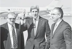  ??  ?? VISITING RUSSIA: Kerry (centre) gestures next to Yuri Filatov (right) of Russian Foreign Ministry Protocol and Alexandr Darchiyev of Russian Foreign Ministry North America’s Department after Kerry’s arrival at Moscow Vnukovo Airport. — AFP photo