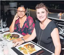  ?? DARIEN ROBERTSON/ FREELANCE PHOTOGRAPH­ER ?? Friends Lisa Hogarth (left) and Debra Lopez pause to share smiles with our camera before indulging in their yummy meals.