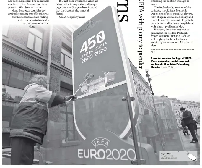  ?? Photo: VCG ?? A worker washes the logo of UEFA Euro 2020 at a countdown clock on March 18 in Saint Petersburg, Russia.