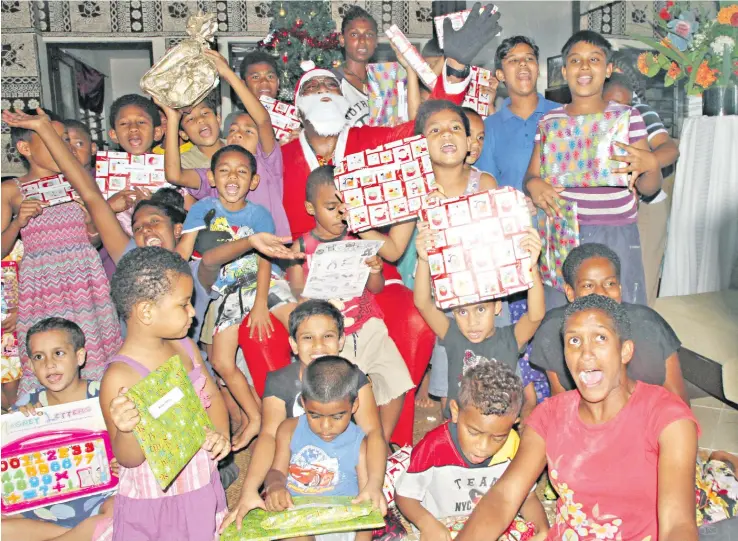  ?? Photo: Vilimoni Vaganalau ?? Christmas joy and smiles shared among the children of Dilkusha Home during the Ministry of Foreign Affairs staff members visit on December 15, 2017.