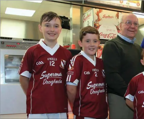  ??  ?? Paddy Mc Donach of Supermacs in the M1 Retail Park presents jersies to Tomas O hEochaidh and Oliver Plunkets players Jason Foley. Ryan
