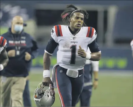  ?? JOHN FROSCHAUER - THE ASSOCIATED PRESS ?? New England Patriots quarterbac­k Cam Newton jogs off the field after an NFL football game against the Seattle Seahawks, Sunday, Sept. 20, 2020, in Seattle. The Seahawks won 35-30.