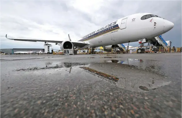  ?? Reuters ?? A Singapore Airlines plane is seen among the planes in the static display at the Singapore Airshow in Singapore.