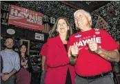  ?? MICHAEL ARES / THE PALM BEACH POST ?? Boca Raton Mayor Susan Haynie holds onto her husband Neil as they celebrate her re-election during a party at Biergarten on Tuesday.