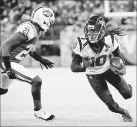  ?? Steven Ryan Getty Images ?? DeANDRE HOPKINS looks for extra yards after a catch against the Jets’ Morris Claiborne. Hopkins had 10 receptions for 170 yards and two touchdowns.