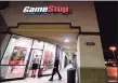  ?? Frederick J. Brown / AFP via Getty Images ?? People enter a GameStop store in Alhambra, Calif., on Wednesday.