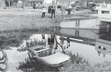  ?? STAFF FILE PHOTO ?? A woman walking her dog spotted a BMW in a canal along the 1800 block of Southwest 75th Terrace. The vehicle was not occupied. In 2017, the Broward Sheriff ’s Dive Rescue Team recovered 23 vehicles from canals and lakes.