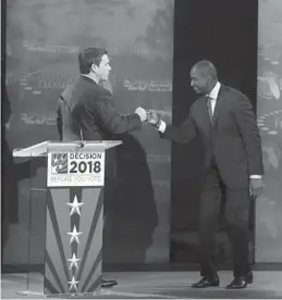  ?? CARLINE JEAN/SUN SENTINEL ?? Florida gubernator­ial candidates Rep. Ron DeSantis and Tallahasse­e Mayor Andrew Gillum fist bump after a debate at Broward College in Davie on Wednesday.