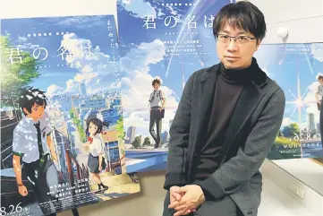  ?? — Reuters photo ?? Anime director Makoto Shinkai poses with posters of his animated film ‘Your Name’ after an interview with Reuters in Tokyo last Novemberr.