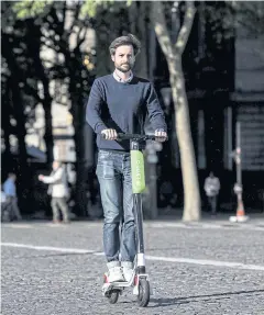  ??  ?? Arthur-Louis Jacquier, director general of Lime France, rides a Lime electric scooter in Paris yesterday.