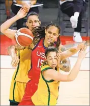  ?? Ethan Miller Getty Images ?? BRITTNEY GRINER, center, loses the ball as Australia’s Marianna Tolo, left, and Jenna O’Hea defend.