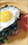  ?? PHOTO BY CATHY THOMAS ?? Sunny side up eggs are served atop kale and toasted rustic bread in this delicious and healthy breakfast dish that can also work for other meals.