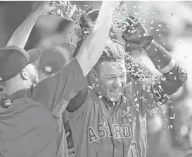  ?? Karen Warren / Houston Chronicle ?? The Astros’ Yuli Gurriel (10) celebrates in the dugout with sunflower seeds after hitting a three-run homer in the seventh inning for the winning margin.