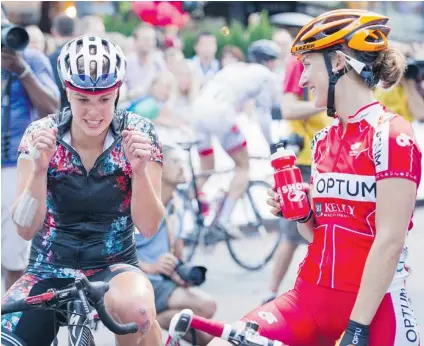  ?? GERRY KAHRMANN/ PNG ?? Gillian Carleton, left, chats with race winner Leah Kirchmann after they competed Wednesday night in the pro women’s 30- lap, 36- kilometre race at the Global Relay Gastown Grand Prix in Vancouver. Carleton’s bandages are from a crash the day before.