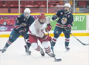  ?? JULIE JOCSAK THE ST. CATHARINES STANDARD ?? St. Catharines’ Josh Urbshott (6) is pursued by Lockport’s Alex Stinis in Greater Ontario Junior Hockey League action Tuesday night. Lockport’s Alexis Stinis (83) battles St. Catharines’ Jacob Roach for the puck.