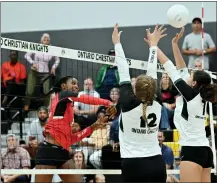  ?? TERRY PIERSON — STAFF PHOTOGRAPH­ER ?? Arrowhead Christian’s Jordyn Wilson, left, hits past Ontario Christian blockers during an Ambassador League match last month.