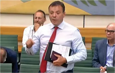  ??  ?? I’m late for lunch! Businessma­n Arron Banks quits the select committee hearing yesterday