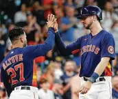  ??  ?? Astros right fielder Kyle Tucker, right, broke a 1-all tie with his two-run homer in the fifth inning.