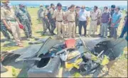  ??  ?? Police personnel inspect the site after a helicopter of the army crashed into the Ranjit Sagar Dam lake in Kathua on Tuesday.