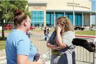  ?? The Associated Press ?? Stephanie Wade, left, comforts her daughter Keeley after she became emotional describing the environmen­t during a school shooting Wednesday at the Timberview High School in Arlington to the media in Mansfield, Texas.