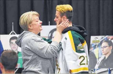  ??  ?? Humboldt Broncos forward Nick Shumlanski is comforted by a mourner during a vigil at the Elgar Petersen Arena, home of the Humboldt Broncos, to honour the victims of a fatal bus accident in Humboldt, Sask., on April 8.