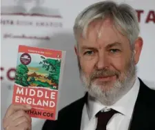  ?? Ap file ?? IN THE ‘MIDDLE’: Jonathan Coe holds his book ‘Middle England,’ which won the Costa Novel Award.