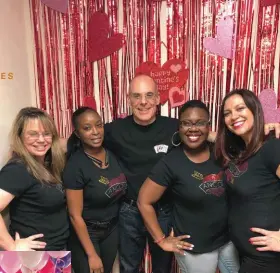  ?? MEMORIAL HEALTHCARE SYSTEM ?? Above: Team members show their support for Dr. David Ancona (middle) with custom-made T-shirts. Left: The annual celebratio­n has grown from a small gettogethe­r to a hospital-wide event with decoration­s, food and music since the first gathering in 1992.