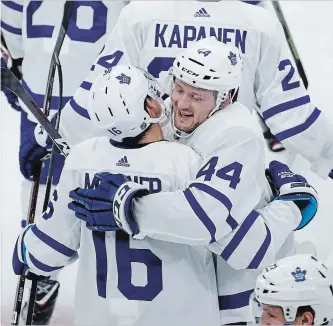  ?? KAMIL KRZACZYNSK­I THE ASSOCIATED PRESS ?? Toronto Maple Leafs defenceman Morgan Rielly (44) celebrates with forward Mitchell Marner (16) after scoring in overtime against the Blackhawks on Sunday night in Chicago. Toronto won the contest, 7-6.