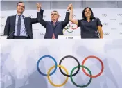  ?? JEAN-CHRISTOPHE BOTT/KEYSTONE VIA AP ?? From left, Mayor of Los Angeles Eric Garcetti, Internatio­nal Olympic Committee President Thomas Bach and Mayor of Paris Anne Hidalgo gesture during a news conference July 11 after the IOC Extraordin­ary Session at the SwissTech Convention Centre in Lausanne, Switzerlan­d.