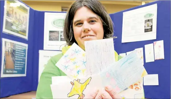  ?? RAISSA TETANISH  TRURO DAILY NEWS ?? Jolene Reid, co- ordinator of Seeding Ideas, holds onto some decorated packs of Bali tomatoes that will be available through the Dalhousie Agricultur­al Campus’s seed library. The library kicks off Monday.