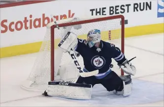  ?? JASON HALSTEAD
GETTY IMAGES ?? Connor Hellebuyck is scored on by Ryan Reaves of the Vegas Golden Knights on Sunday. It turned out to be the winning goal in a 2-1 victory. The Winnipeg goalie had a good year, but his team faced a wall in Fleury.