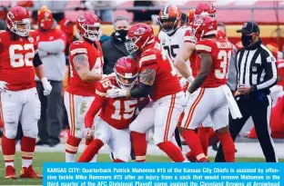  ?? —AFP ?? KANSAS CITY: Quarterbac­k Patrick Mahomes #15 of the Kansas City Chiefs is assisted by offensive tackle Mike Remmers #75 after an injury from a sack that would remove Mahomes in the third quarter of the AFC Divisional Playoff game against the Cleveland Browns at Arrowhead Stadium on Sunday in Kansas City, Missouri.