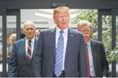  ?? Leon Neal / Getty Images ?? Trump leaves with Chief of Staff John Kelly and national security adviser John Bolton after holding a news conference.