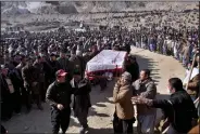  ?? (AP/Arshad Butt) ?? People carry the remains of a slain coal miner Saturday in Quetta, Pakistan.