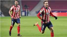  ??  ?? Atletico Madrid's Saul Niguez (right) celebrates after scoring against Sevilla on Tuesday