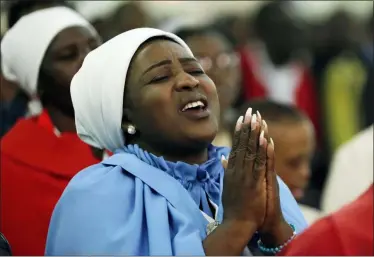  ?? THEMBA HADEBE — THE ASSOCIATED PRESS ?? A church member prays during the Sunday mass at the Roman Catholic Church in Harare, Zimbabwe, Sunday a church that Robert Mugabe regularly attended. Days of official mourning have begun in Zimbabwe for Robert Mugabe, who had become a national hero despite decades of rule that left the country struggling. Mugabe, an ex-guerrilla chief who took power in 1980 when Zimbabwe shook off white minority rule and presided for decades while economic turmoil and human rights violations eroded its early promise, died Friday at a hospital in Singapore.