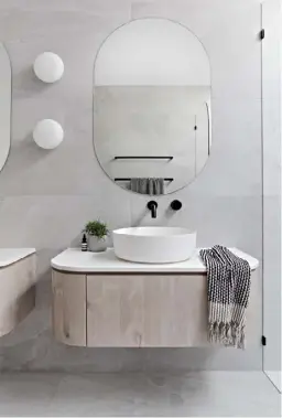  ??  ?? In this Scandi-style ensuite by Zephyr and Stone, the sconces complement the vanity and basin, creating a sense of cohesive calm that suits the sleek space.