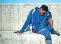  ?? File/ Agence France-presse ?? A migrant rests after arriving aboard a coast guard boat at Algecira’s harbour.