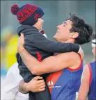  ?? ?? Dad duties: Darcy Robinson celebrates a win with his son in 2019.
