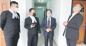  ??  ?? (From left) Defence counsels Jonathan Tay and George Lo having conversati­on with Wong and See outside the court.