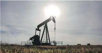  ?? JEFF McINTOSH, CP ?? A pumpjack works at a well head on an oil and gas installati­on near Cremona, Alta.