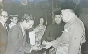  ?? ?? dr M. Jayaraman receiving his AMN title from the yang dipertuan agong in 1976 for his contributi­ons as the first rukun Tetangga chairman in the country.