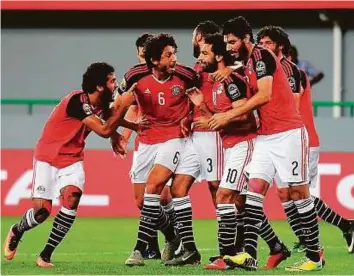  ?? AFP ?? Egypt’s forward Mohamed Salah (centre) celebrates with teammates after scoring a goal against Ghana during the 2017 Africa Cup of Nations Group D match in Port-Gentil on Wednesday.
