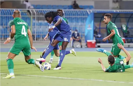  ?? AFP ?? Hilal’s forward Bafetimbi Gomis, center, attempts a shot during the AFC Champions League Group A match between Al-Hilal and Shabab Al-Ahli.