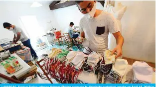  ?? — AFP ?? LAVARDAC, France: Syrian refugee Hekmat Shikho prepares to distribute protective masks on April 16, 2020 in southweste­rn France, where he and his family found asylum after fleeing the war in Syria.